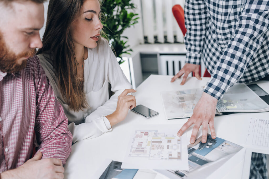 Couple in Real-Estate Agency Talking to Real Estate Agent