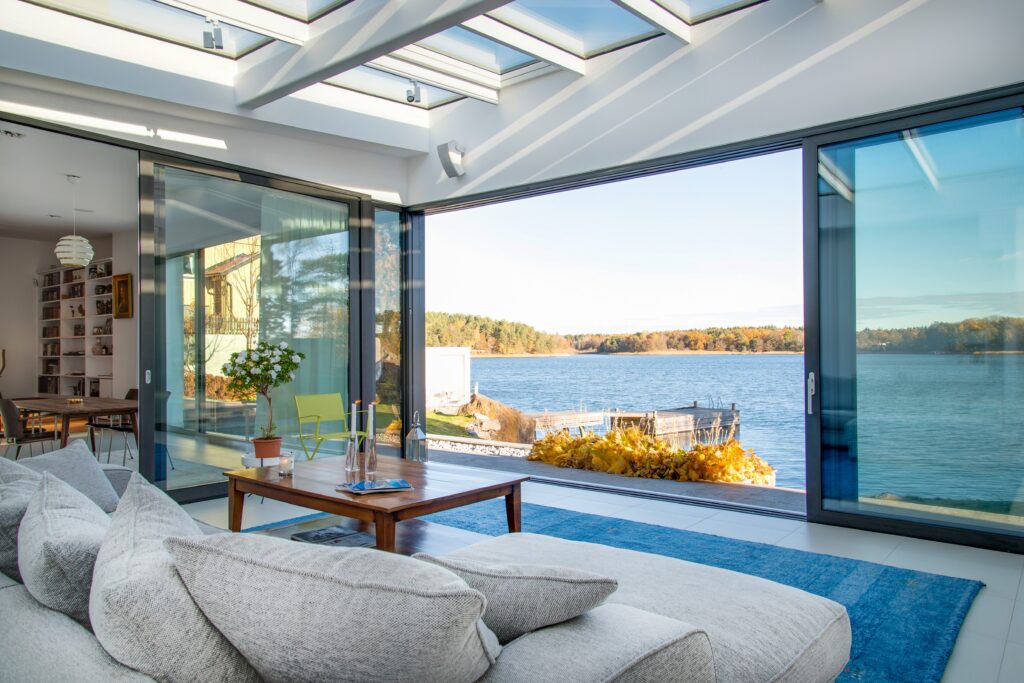 Luxury beach house with glass windows and the beautiful scenery of the sea in the background